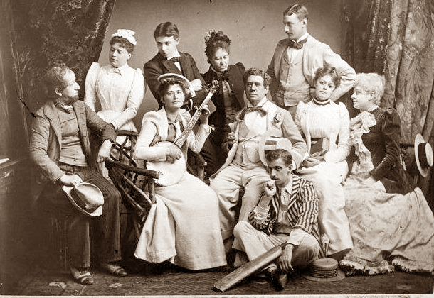 Toole (seated, centre) with the cast of J. M. Barrie's Walker, London, 1892 Walker-London-1892-Toole's-Theatre.png