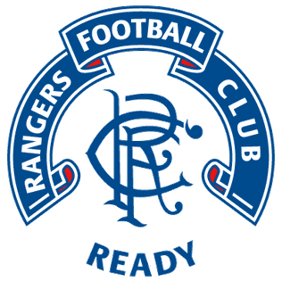 Scroll crest version with banner and 'Ready' motto, worn on shirts between 1990 and 1995.