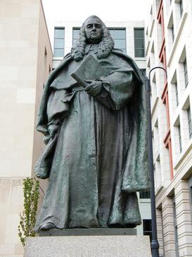 A statue of Sir William Blackstone by Paul Wayland Bartlett in front of the E. Barrett Prettyman United States Courthouse in Washington, D.C.