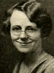 A smiling white woman in her late 20s, with wavy light hair cut into a bob with a side part