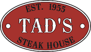 Tad's logo.  Red oval with "TAD'S" in the middle, "Est. 1955" at tope and "STEAK HOUSE" on the bottom.