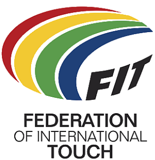 Logo showing a multicolored, stylized, oval-shaped, football. Four approximately concentric crescent shapes (red, yellow, green and blue on a white or light-colored background) are used to form the top and left parts of the ball. The three black capital letters F, I and T (all slightly curved and on the same white or light-colored background) are used for the bottom-right of the ball. The words "Federation of International Touch" (split over three lines of text) are positioned below the stylized ball.