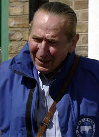 grey-haired man in a padded coat