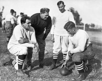 1924 Stanford team: line coach Claude E. Thornhill, Warner, assistant Andrew Kerr and team captain Jim Lawson.