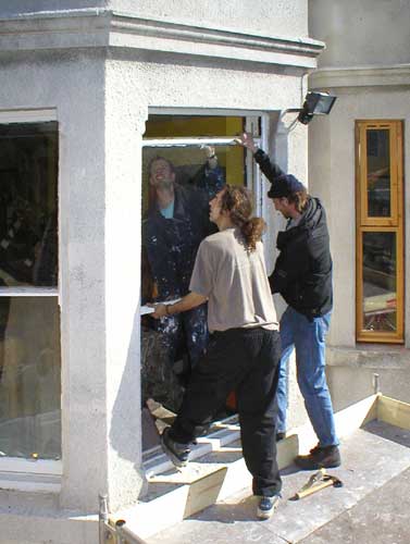 Volunteers fit new windows at the Sumac Centre in Nottingham, England, UK.