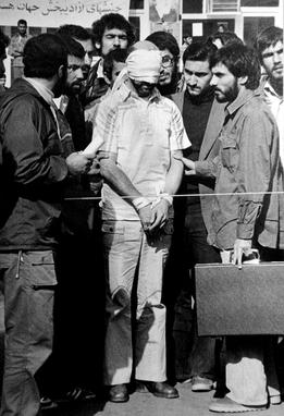 Barry Rosen, the embassy's press attaché, was among the hostages. The man on the right holding the briefcase is alleged by some former hostages to be future President Mahmoud Ahmadinejad, although he, Iran's government, and the CIA deny this.