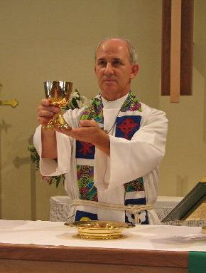 A Lutheran priest elevates the chalice in the celebration of the Holy Mass.