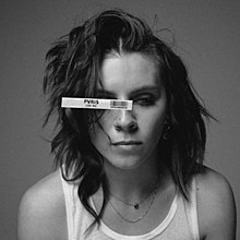 A black-and-white photo of Lynn Gunn, with a UPC code stuck on