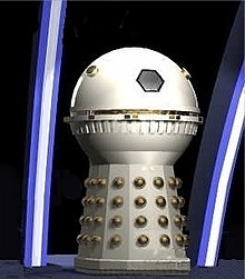 A cream-coloured Dalek with a spherical head section and no appendages. The hemispheres and detailing around the dome midsection are painted in gold.