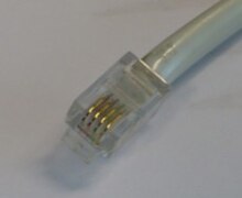 4P4C modular connector on a handset cord. RJ9.jpg