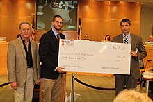 Jeremy Everett presents a check to Houston ISD for their work in Breakfast in the Classroom THI Breakfast.jpg