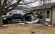 Central portion of first image of aircraft debris tweeted out by Broomfield Police illustrating their response to the event. Image shows the engine inlet rim fairing where it landed. 2021-02-20-13-50 BroomfieldPD.jpg