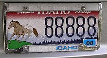 An Idaho car license plate with a running horse on the left side. The horse is brown with a brown and white spotted rump