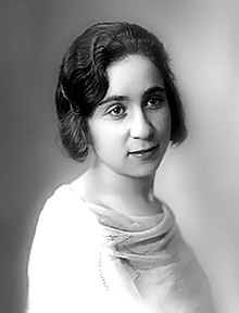 portrait of a woman with waved hair in a 1920s style white blouse