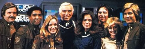 Promotional photo of the cast of Battlestar Galactica (1978). From left to right: Tony Swartz as Jolly, Herbert Jefferson Jr. as Boomer, Anne Lockhart as Sheba, Lorne Greene as Adama, Maren Jensen as Athena, Richard Hatch as Apollo, Laurette Spang as Cassiopeia and Dirk Benedict as Starbuck. Battlestar Galactica (1978) cast.jpg