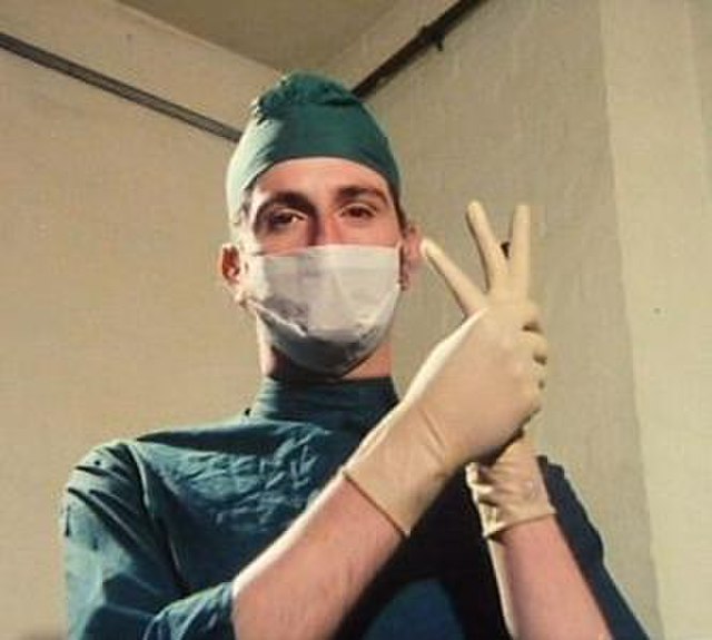 Adams in his first Monty Python appearance, in full surgeon's garb