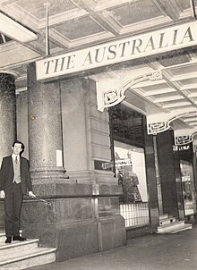A patron stands on the marble steps of the doomed Australia Hotel. The closure notice is pasted on a column. Hotel Australia(2).jpg