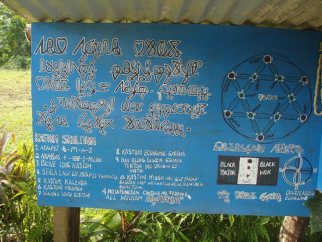 A sign in Bislama written in boustrophedon Avoiuli script, from the island of Pentecost. The top-left reads, sab senta blong melenisian institiut blon