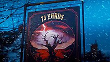 The text "73 Yards" in gold letters on a black banner in the Welsh countryside. Snow falls around the banner and an image of a barren tree with a red color-graded background sits below the text.