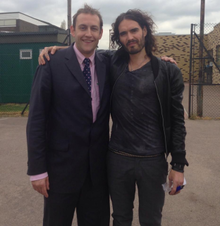 Russell Brand and Principal James Howarth James Howarth and Russell Brand at the Hathaway Academy.png