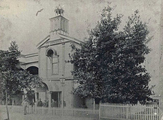 Townsville's Town Hall 1895 with, from left to right, Aldermen T. Enright, E.J. Forrest, D.F. Treehy (Townclerk), P. Lillis (Rate Receiver), J. N. Par