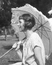 Black and white photographic portrait of Dorothy Kay, seen in profile as a young woman holding a parasol.