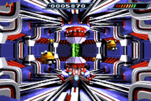 Bosses such as the Refusor usually have a single vulnerability--here, the green core. From top left, the number of lives remaining, score, and ship energy are shown. Gba iridionbosslvl.png