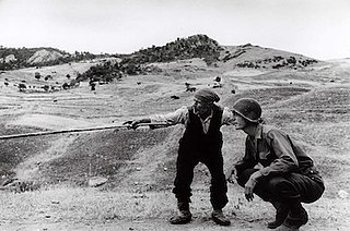 <i>Sicilian Peasant Telling an American Officer Which Way the Germans Had Gone</i> Photograph by Robert Capa