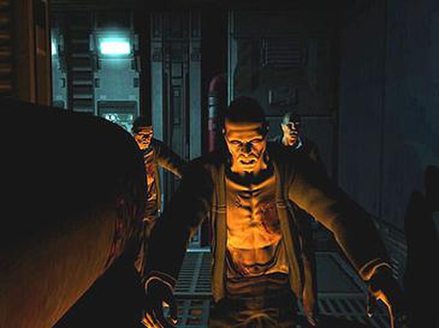 The shadowing effects of the unified lighting and shadowing engine are shown on the face and body of the zombies in this screenshot of Doom 3.