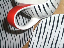 Close up of a jug and side plates in the popular Zambesi design, 1950s Midwinterzambesi.jpg
