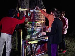 McCartney, Harrison, Starr and Lennon pouring paint over the piano–harp construction. Journalist and broadcaster Joe Cushley describes the clip as the mad music professors' outdoor seminar.[123]