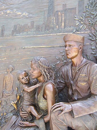 Sculpture of a sailor and his family, gazing eastward over Lake Michigan