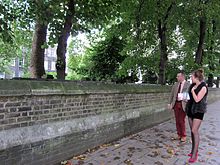 Passers-by look for the phantom railings in Malet Street. Phantom Railings of Malet Street Gardens.JPG