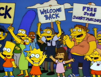 A scene from the episode, featuring a sign reading "Free John Swartzwelder", referencing one of the series' writers FreeSwartzwelder.png