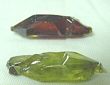 The red and green colors of these synthetic ZnO crystals result from different concentrations of oxygen vacancies. Synthetic Zincite Crystals.jpg