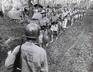 Filipino guerrillas under the command of Captain Jesus Olmedo come out to meet Major General A.V. Arnold at U.S. Army 7th Division headquarters for a conference in 1944. Filipino Guerrillas Under Captain Jesus Olmedo Come Out To Meet 7th Division Command Post For Conference With Major General A.V. Arnold Cropped.jpg