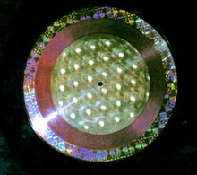 Han-O-Disc record with diffraction grating 'Rainbow' film (outside ring), color shifting Rowlux (middle ring) and "silver balls" Rowlux film (center of record). Rolux.jpg