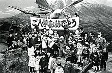 School children visiting the set during production, posing with some of the cast, monster suits and props.