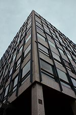 The office building at the start of Ermou Street on Syntagma Square. It was designed in 1961 by Dimitris Papazisis and its interior by Takis Zenetos. It has a curtain wall made of I-beams, marble, and glass. Office building on Syntagma Square and Ermou Street, Athens.jpg