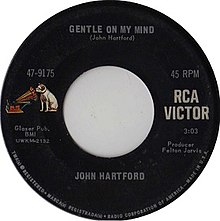 Black RCA Records 7-inch single label. On the left side, a drawing of a dog staring into a gramophone is seen. On the Right side, a text reads RCA Victor. The top reads Gentle on My Mind (John Hartford). The bottom reads John Hartford.