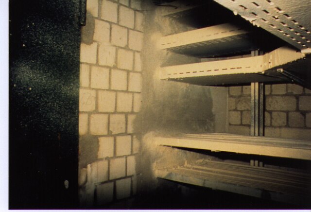 Fire-resistance rated wall assembly with fire door, cable tray penetration and intumescent cable coating