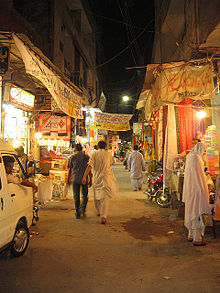 Present view of the Ichhra Bazaar (Market) at night. The market, because of being designed in very old style is very narrow for vehicles to cross and shoppers to walk. Ichhra Bazaar.jpg