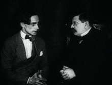 A scene from Different from the Others (1919), a film made in Berlin, whose main character struggles with his homosexuality KoenerAndHirschfeld.png