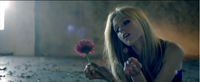 Shows Lavigne alone with a flower. Avril Lavigne - Wish You Were Here screenshot.png