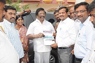 SGEIs Chairman Sri. Gunda Reddy hands over cash cheque to the Minister towards Chief Minister's Disaster Relief Fund SGC Social Work.jpg