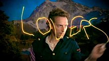 Chris Martin light painting the word "Lovers" in the music video. Loversinjapan.jpg