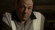James Gandolfini as Tony Soprano. He is looking up with an inscrutable expression.