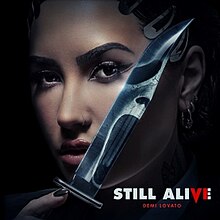 Cover artwork of "Still Alive" showing Lovato with a dagger reflecting the image of Ghostface.