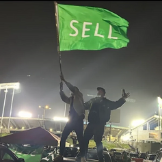 Fans protest during 2024 MLB Opening Day, the Oakland Coliseum is also pictured on background, the green SELL flag became a symbol of the moviment against the A's move. Oakland As Protest.png