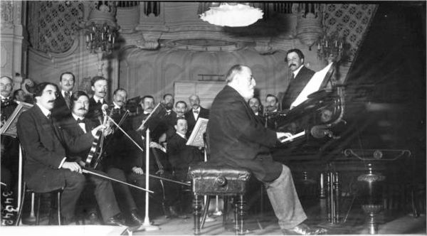 Saint-Saëns at the keyboard, with Monteux (right) on the rostrum, 1913